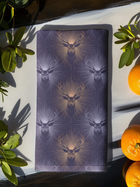 Set of four slate blue dining napkins featuring alternating gold and silver ravens in flight with botanical accents, sized 18x18 inches.